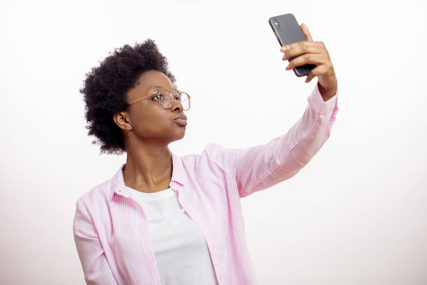 close up side view portrait of a afro woman posing for the selfie - Photo, image