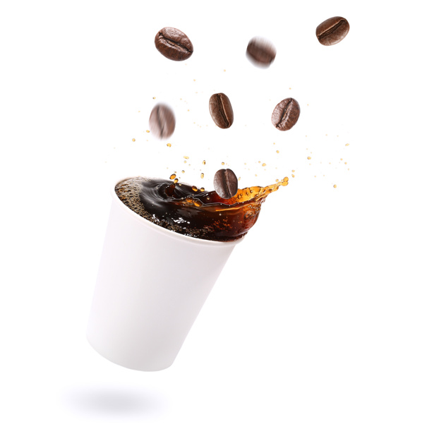 Cup of hot coffee with splash and falling beans on white background - Photo, Image