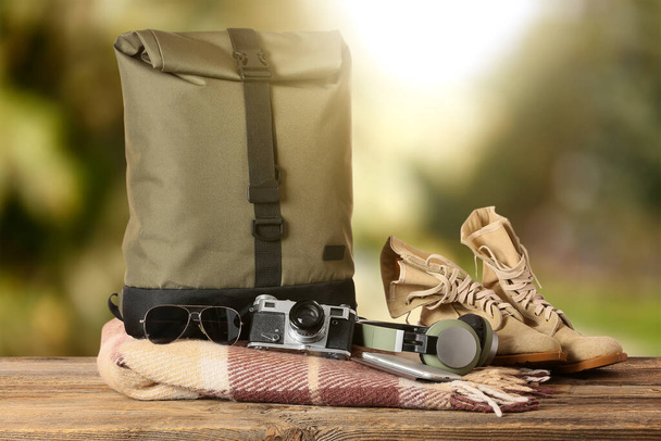 Set of traveler's accessories on table against blurred background - Fotografie, Obrázek