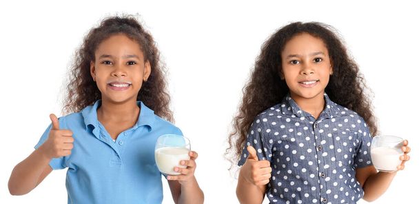 Malá afro-americká dívka s mlékem ukazující palec nahoru gesto na bílém pozadí - Fotografie, Obrázek