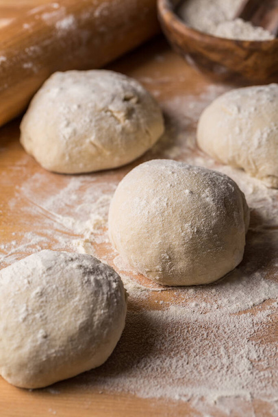 Freshly prepared yeast dough for on wooden background. Home cooking concept. - Foto, afbeelding