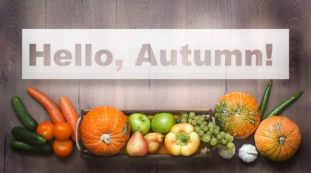 Hello, Autumn. Text written on a background of pumpkins and various fruits and vegetables. High quality photo - Photo, Image