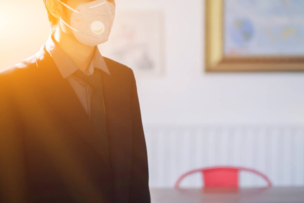 A young businessman wearing a mask to protect the corona virus (COVID-19) that may spread in the air and the mask also protects against small dust or PM 2.5 that is causing problems every year - 写真・画像