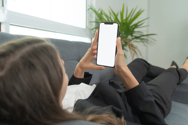 Woman using a blank empty screen space on smartphone or mobile phone on webcam video call conference or using application in quarantine. Mock up device. - Foto, Imagem