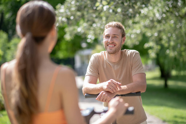 Young man and woman talking in the park - Photo, image