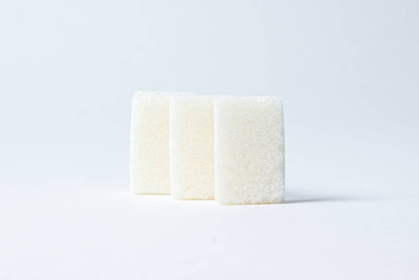 Refined sugar on a white background. White sugar cubes. - Photo, Image
