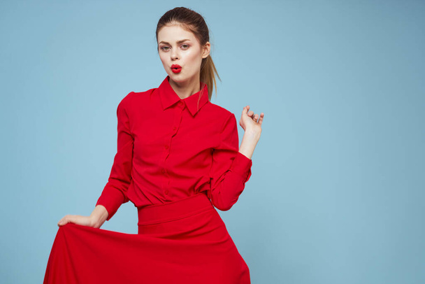 attractive woman in bright clothes on blue background gesturing with hands and red lips makeup cropped view emotions - Foto, imagen