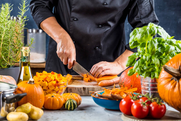 cropped shot of chef chopping carrots for pumpkin soup - Foto, Imagem