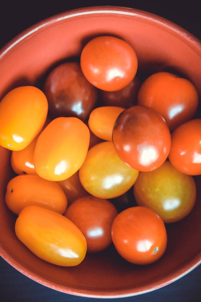 Colorful cocktail tomatoes in a bowl. Top view - 写真・画像
