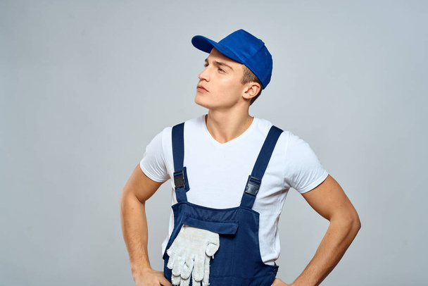 working man in uniform service lifestyle delivery service light background - Фото, изображение