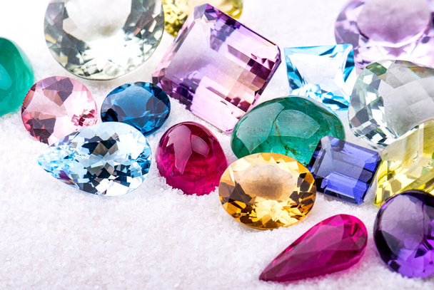 Group of gemstones on white sand with studio lighting. - Photo, Image