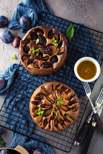 top view of delicious sweet fruit pies with plums on table - Фото, зображення