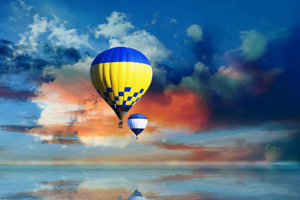 Fantastic dreams. Hot air balloons in blue sky with clouds over sea - Φωτογραφία, εικόνα