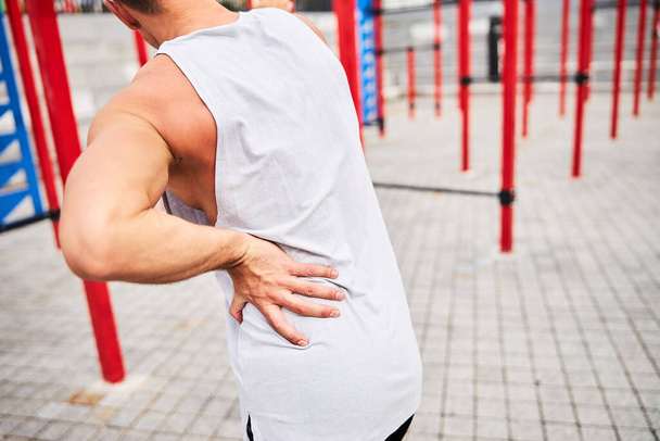 Muscular man got sprain during workout outdoors - Fotoğraf, Görsel