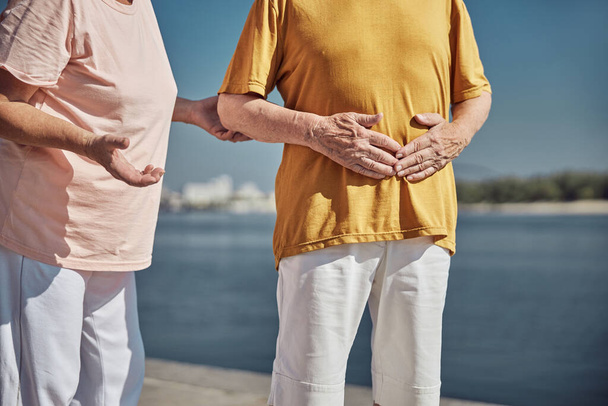 Senior Caucasian man holding his stomach with both hands - Photo, image