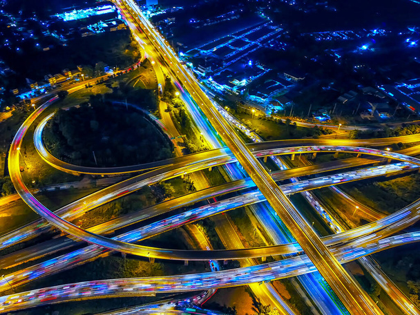 Aerial view of Circle Road traffic in roundabout and highway at night. Expressway, Modern transportation, Multilevel junction highway, Important infrastructure of transport in Thailand, Top view. - Photo, Image
