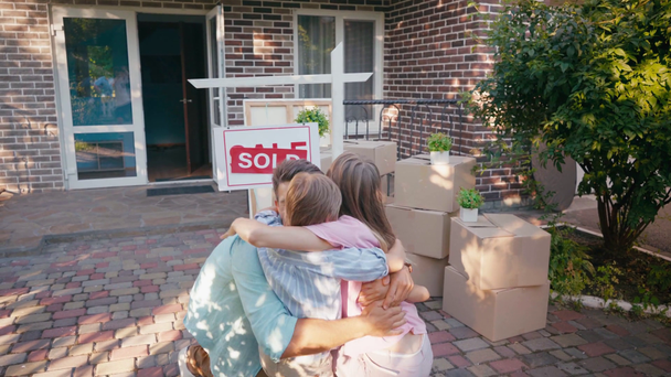 joyful family giving high five and hugging near new house  - Video, Çekim