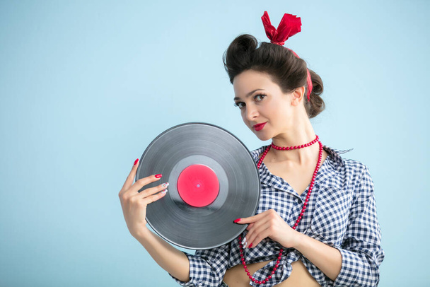 Retro girl with a record.Fifties style woman. - 写真・画像