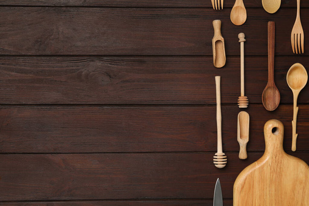 Set of modern cooking utensils on brown wooden table, flat lay. Space for text - Фото, зображення