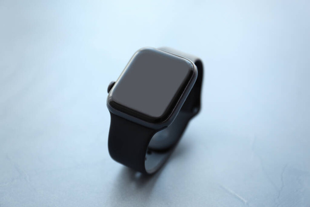 Stylish smart watch on grey stone table, closeup - Zdjęcie, obraz