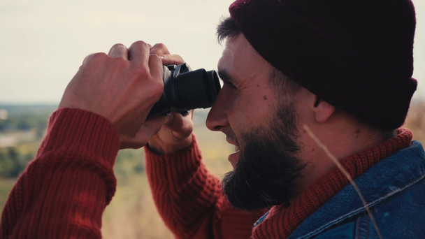 Side view of traveler looking through binoculars outside - Footage, Video
