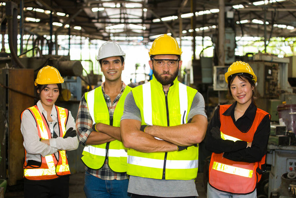 Groep van een multi-etnische fabrieksarbeider, staan en met armen gekruist voor hun magazijn. - Foto, afbeelding