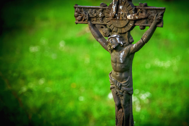 Partially destroyed ancient iron statue of the crucifixion of Jesus Christ  - Photo, Image