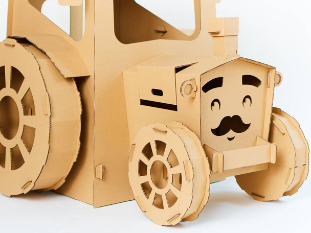 Cardboard tractor on a white background. Agriculture concept. Mockup for design with copy space. - Foto, immagini
