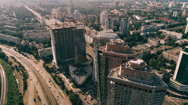 Aerial view of unfinished skyscrapers and cityscape - Footage, Video