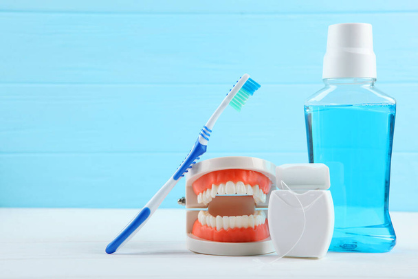 Dental model of teeth and dental care products on colored background with place for text - Foto, immagini