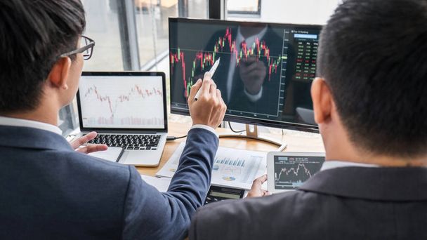 Business team partner working with computer, laptop, discussion and analyzing graph stock market trading with stock chart data planning, financial and investment concept. - Photo, Image
