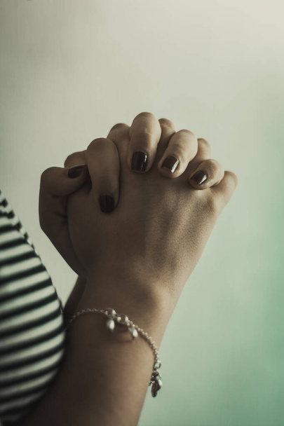 Hands of young girl in prayer position and praying in silence close-up. Copy space - Photo, Image