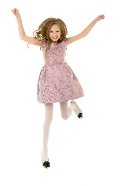 Beautiful Blonde Girl Happily Jumping with Raising Hands - Фото, изображение