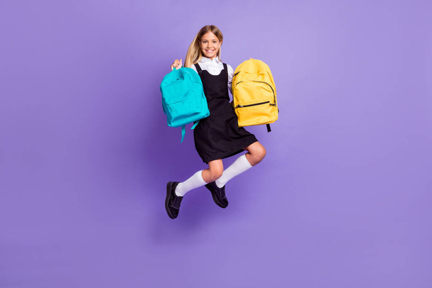 Full length body size view of her she nice attractive cheerful small little girl jumping carrying bags autumn season isolated bright vivid shine vibrant lilac violet purple color background - Photo, Image