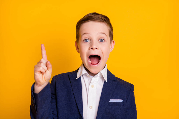 Close-up portrait of his he handsome intelligent cheerful cheery small little boy learner nerd find solution pointing up great idea isolated bright vivid shine vibrant yellow color background - Photo, Image