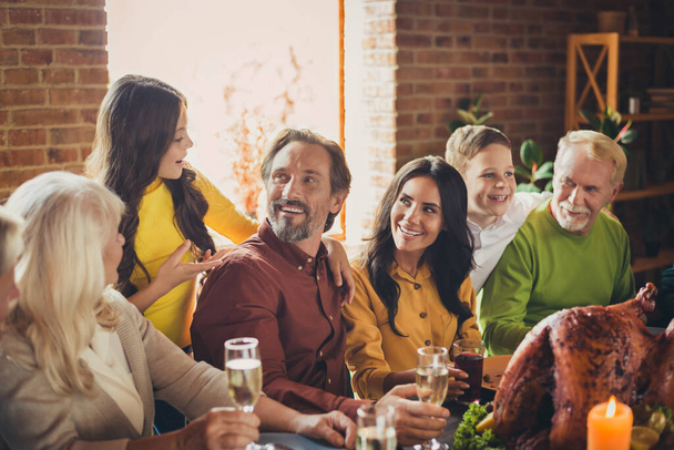 Portrait of full family communicating thanks giving party meeting sit served dinner turkey table living room indoors - 写真・画像