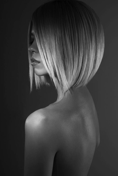 Fashion studio portrait of lovely asian woman with blonde short hair. Fashionable haircut. Black and white photography - 写真・画像