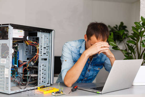 μηχανικός υπολογιστών που εργάζεται σε σπασμένη κονσόλα - Φωτογραφία, εικόνα
