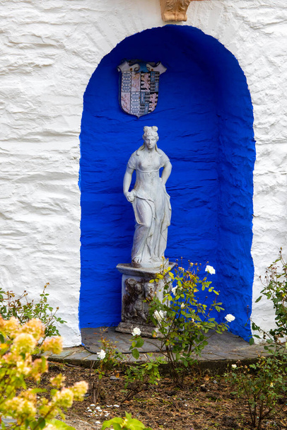 Portmeirion, Wales - September 1st 2020: A classical style sculpture, located outside the exterior of The Round House in the village of Portmeirion in North Wales, UK. - Fotó, kép