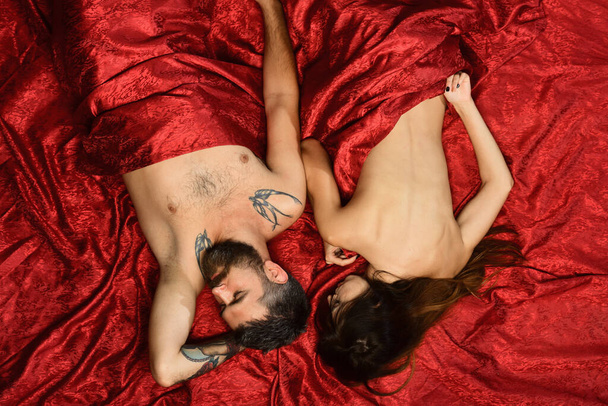 Man and woman with half covered bodies lie in bedroom - Photo, image