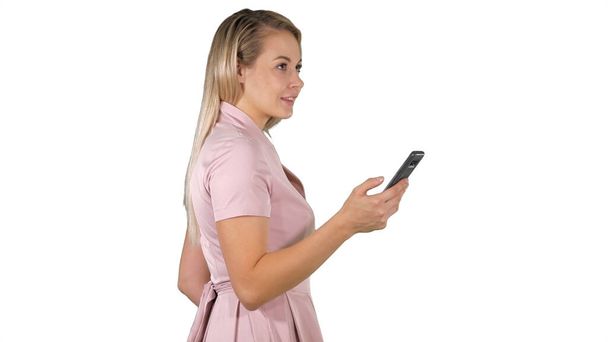 Happy woman selecting on line content in a smart phone on white - Foto, imagen