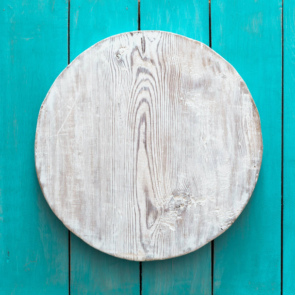 grunge empty round wooden plate on old wooden table, background with copyspace - Photo, Image