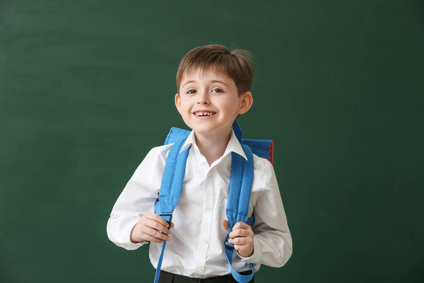 Little schoolboy on color background - Foto, afbeelding