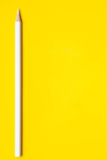 Vertical white sharp wooden pencil on a bright yellow background, isolated, copy space, mock up - Фото, изображение