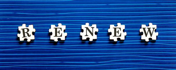 Puzzle piece with RENEW text on blue background. - Photo, Image
