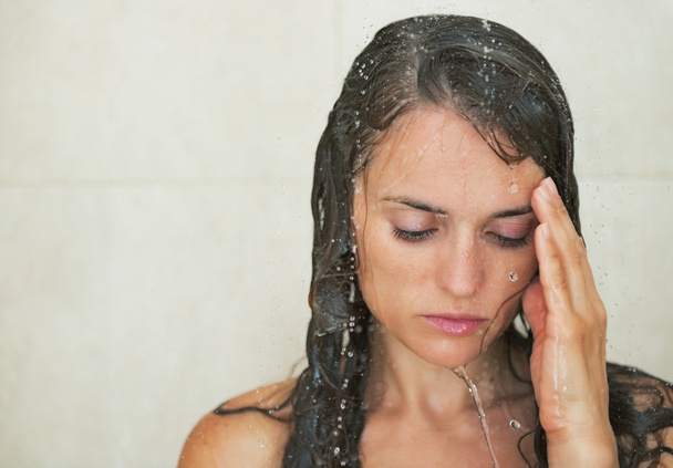 Portrait of frustrated young woman in shower - Fotó, kép