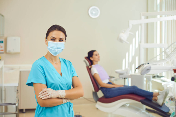 Doctor dentist standing and looking at camera in dental clinic during examination - Foto, immagini