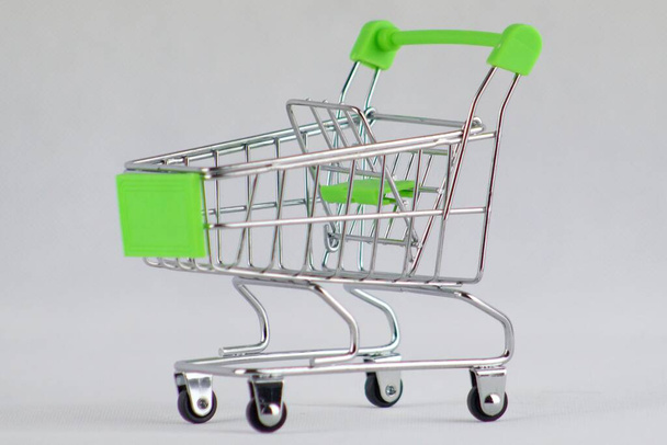 Empty green shopping cart on isolated white background. Go shopping. - Photo, Image
