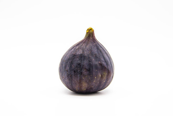The One fig isolated on a white background. View of ripe purple violet fig. - Valokuva, kuva