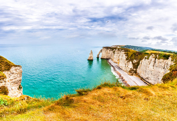 Panorama of natural chalk cliffs of Etretat with visible arche and beach coastline, Normandy, France, Europe - 写真・画像